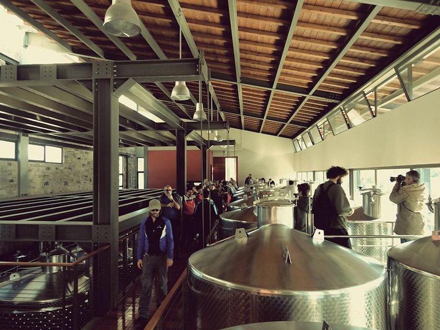 4IVi6Jxb_tourists on the corridor between storage tanks on the top of these at Domaine Papagiannakos premises.jpg